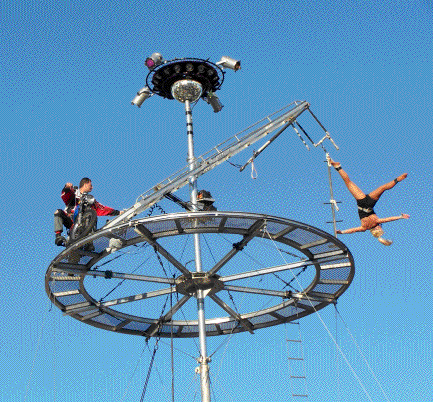 Tina begins her routine on the aerial trapeze
